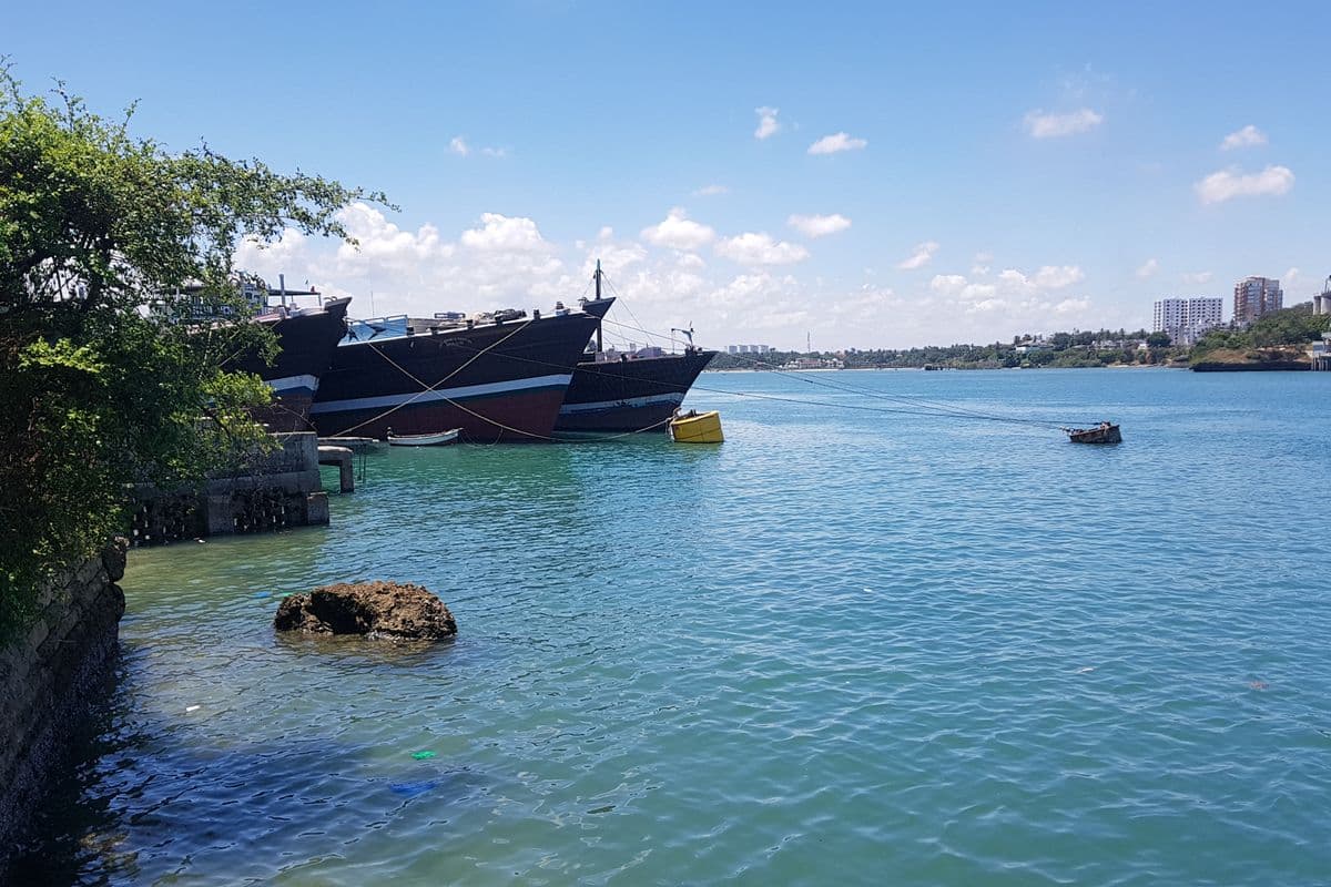 Old Town Mombasa import dock with goods being unloaded from a small vessel