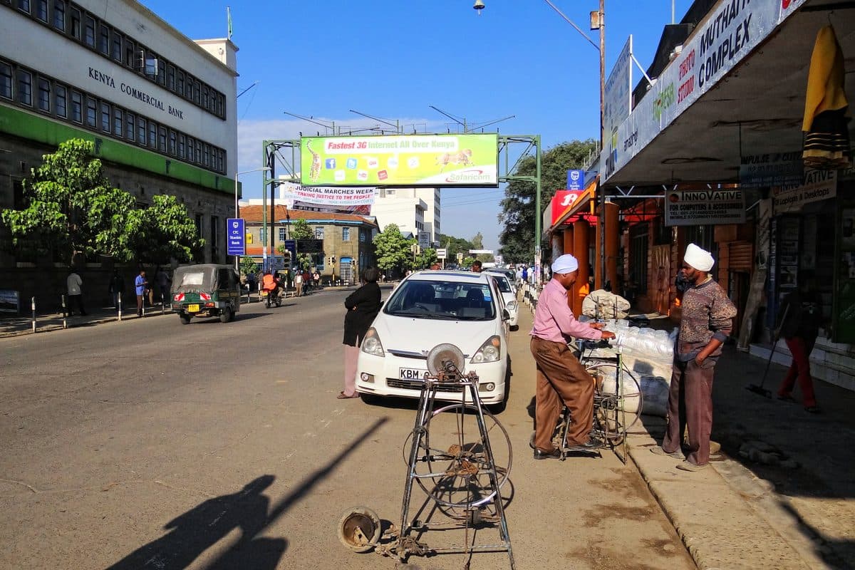Kenyatta Avenue, the main commercial street through Nakuru city centre, showing shops and pedestrians